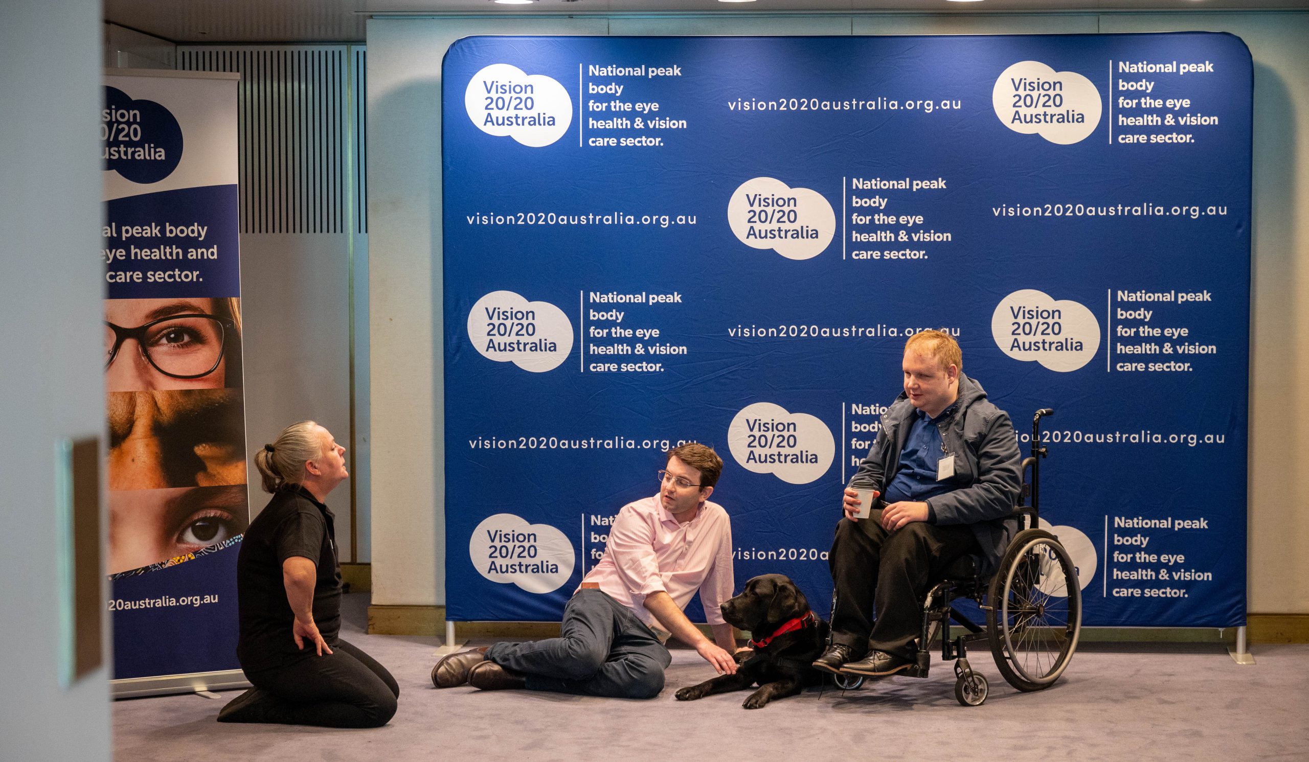 Vision 2020 staff interacting with a Guide Dog.